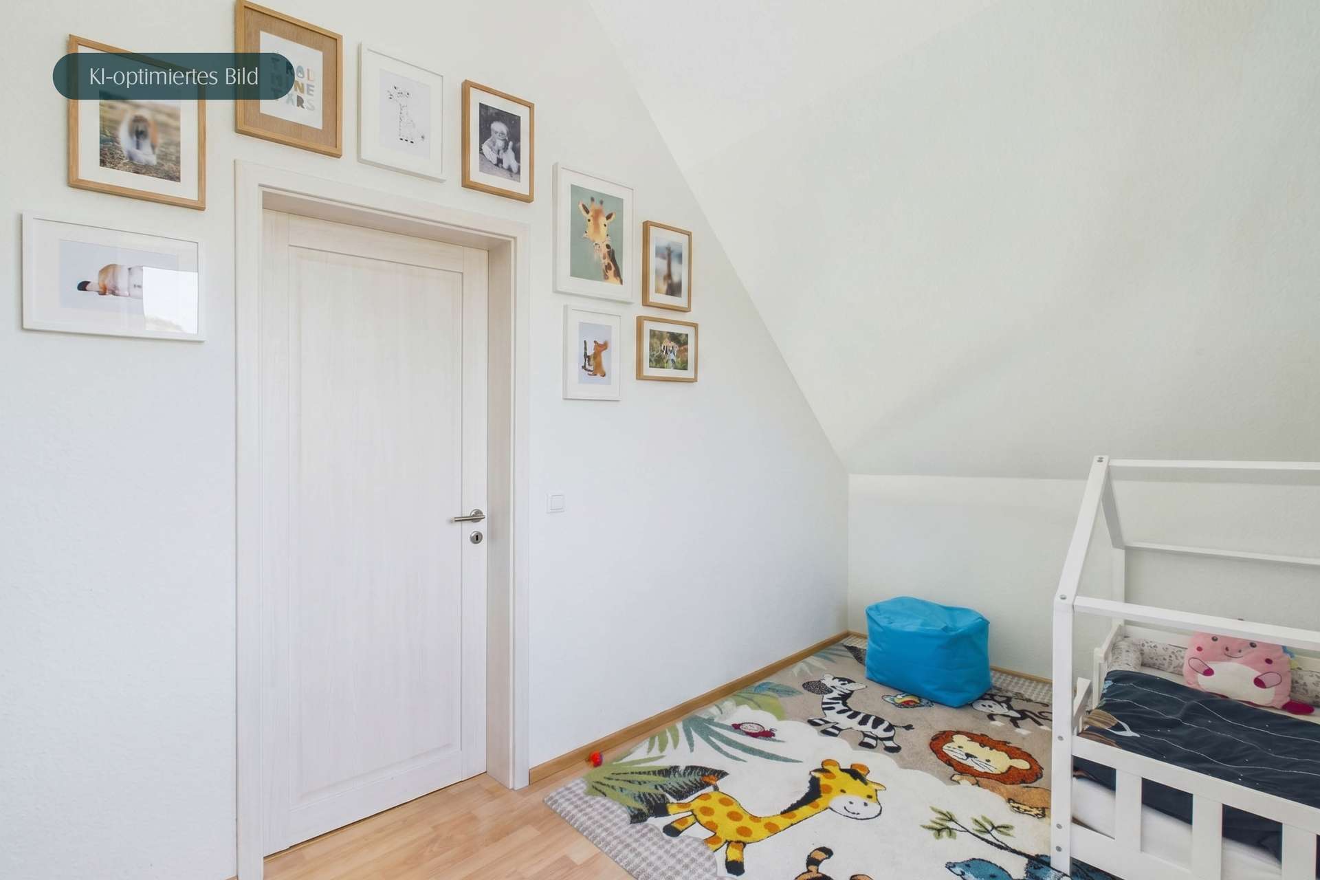 Ein helles Kinderzimmer mit einem Bett, einem Teppich mit Tieren und gerahmten Bildern an der Wand.