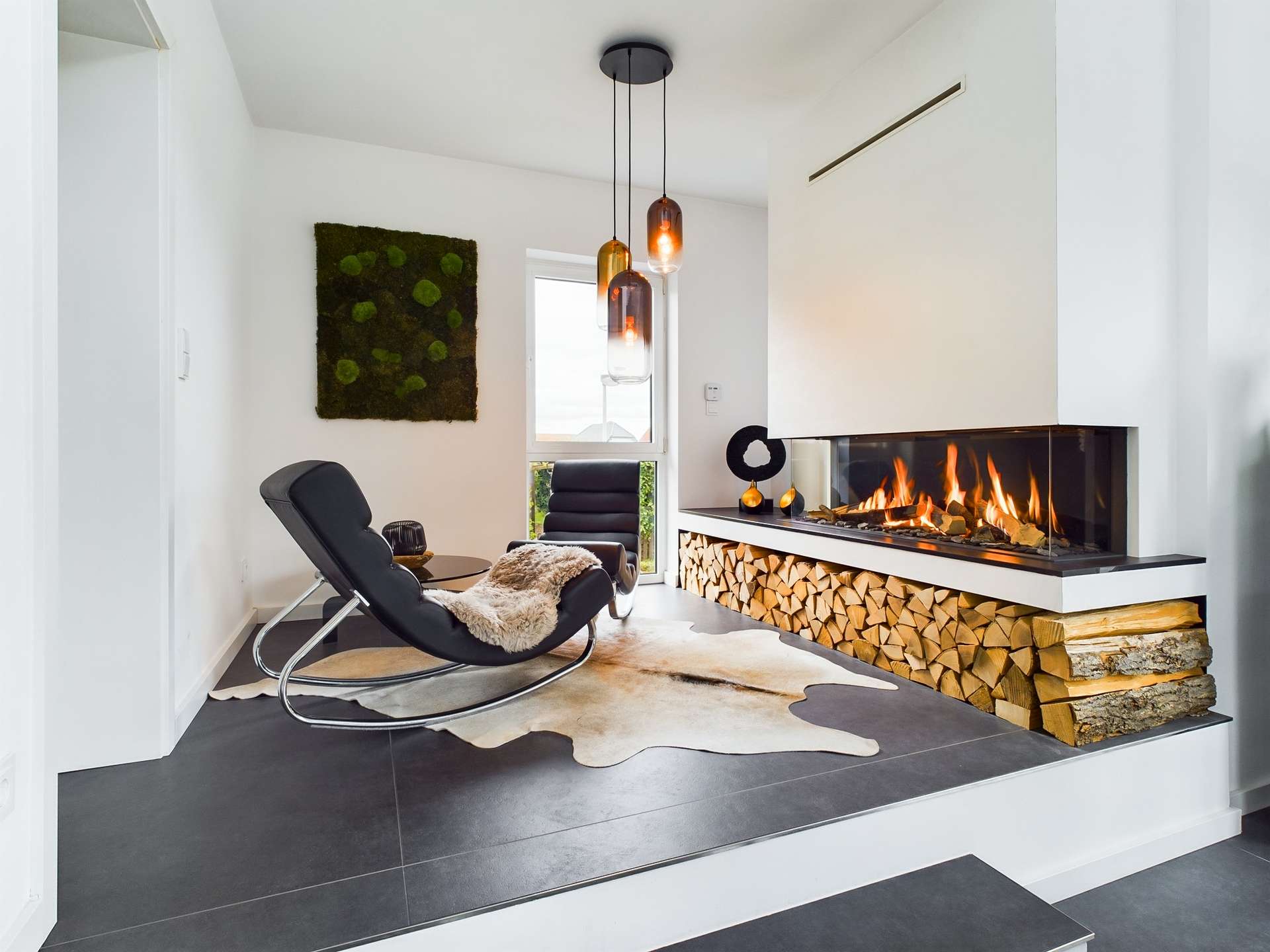 Moderne Wohnatmosphäre mit Kamin, Holzstapel, Stuhl und Teppich in neutralen Tönen.